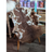 Brown and white tibet highland spotted grade a- sheepskin rug draped over a chair for cozy decor