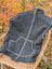 Dark gray woolen jasper vest with ribbed knit, full zipper, matching pocket trim made from soft fleece zealand wool