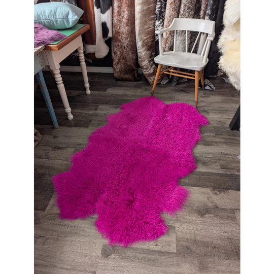 Vibrant hot pink Angus Oliver sheepskin rug, plush fluffy texture