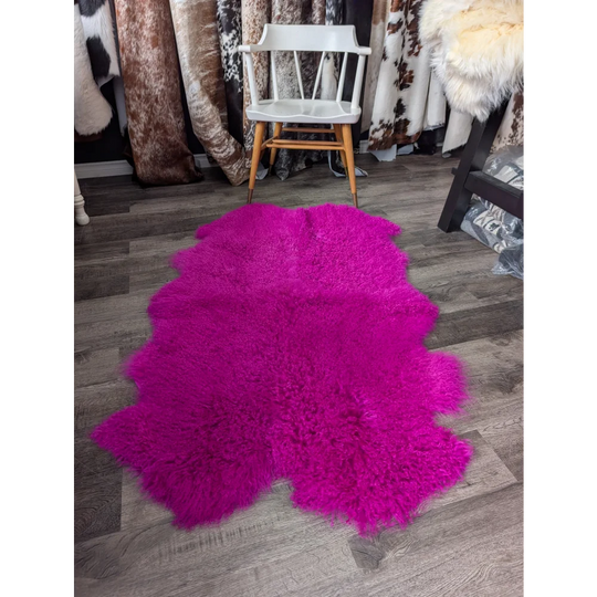 Vibrant hot pink Angus Oliver sheepskin rug, plush fluffy texture
