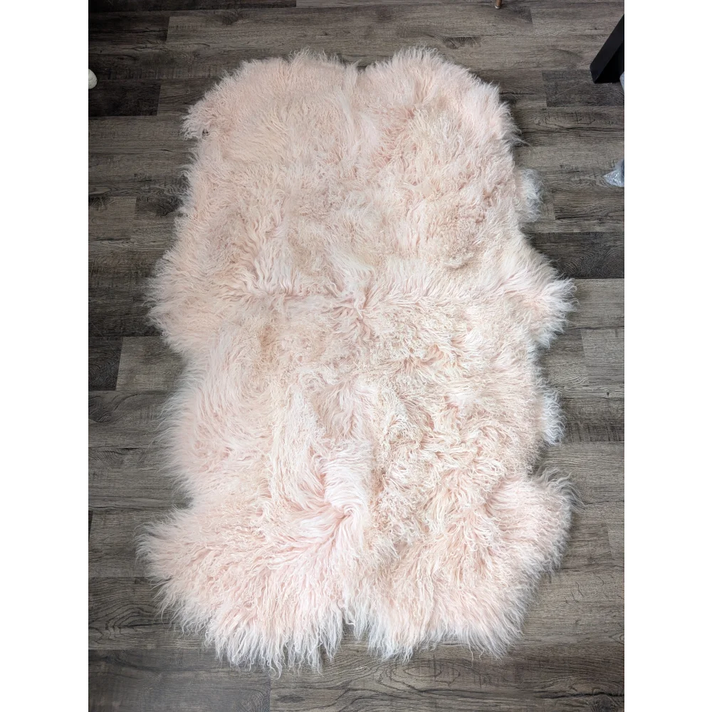 Blush pink 69x43 Angus Oliver sheepskin rug on wood floor