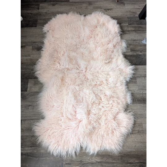 Blush pink 69x43 Angus Oliver sheepskin rug on wood floor