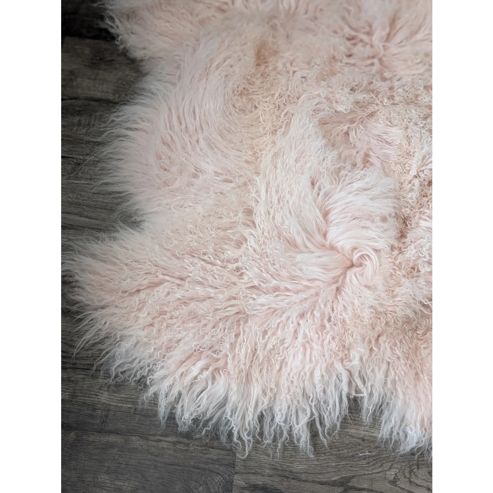 Blush pink 69x43 inch Angus Oliver sheepskin rug with curly texture