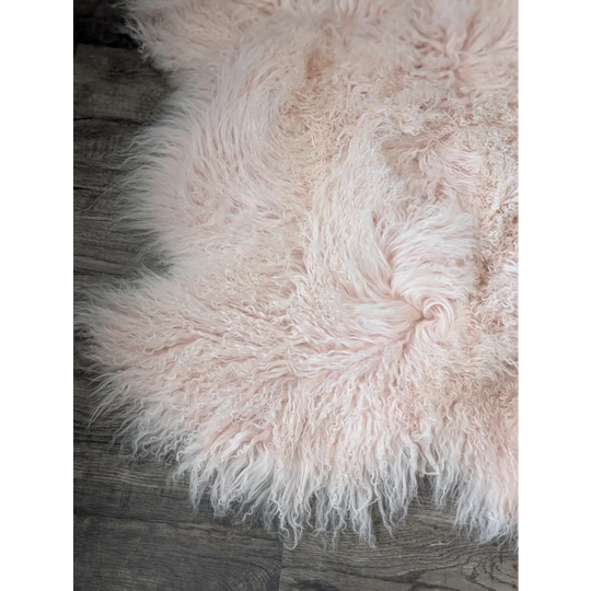 Blush pink 69x43 inch Angus Oliver sheepskin rug with curly texture