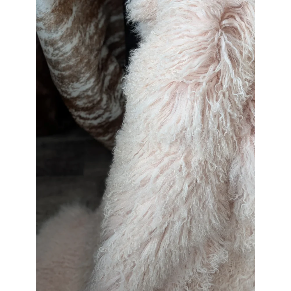Blush pink Angus Oliver sheepskin rug with plush curly white fur coat texture