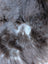 A plush dark gray british isles sheepskin rug with soft dense faux fur and subtle lighter gray and white patches