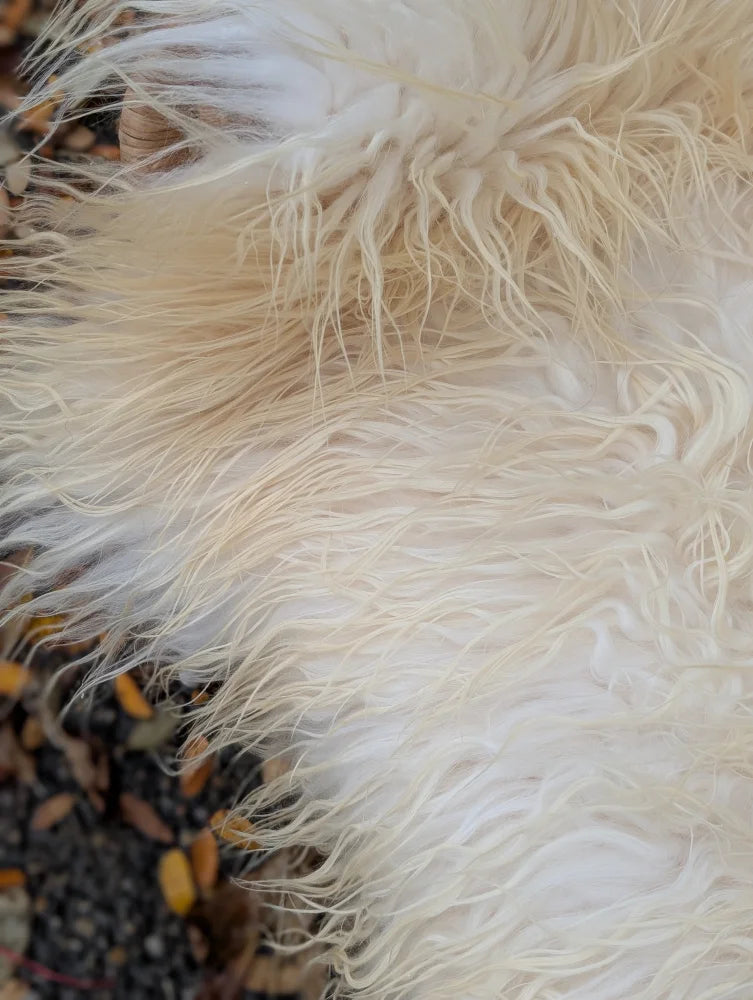 A plush natural white icelandic sheepskin rug with long soft wool and slightly curly fibers perfect for cozy decor