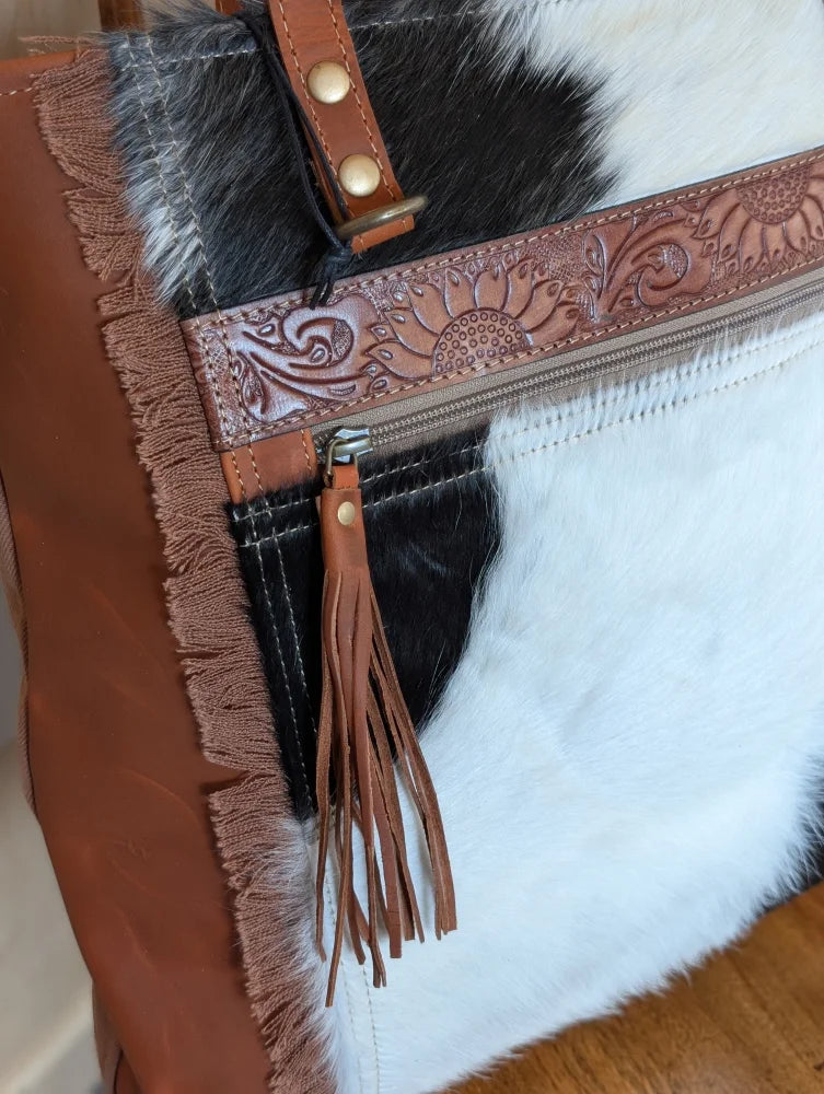 Brown leather clutch real cowhide with frayed edges floral tooled strap tassel zipper pull oakley specks canvas look