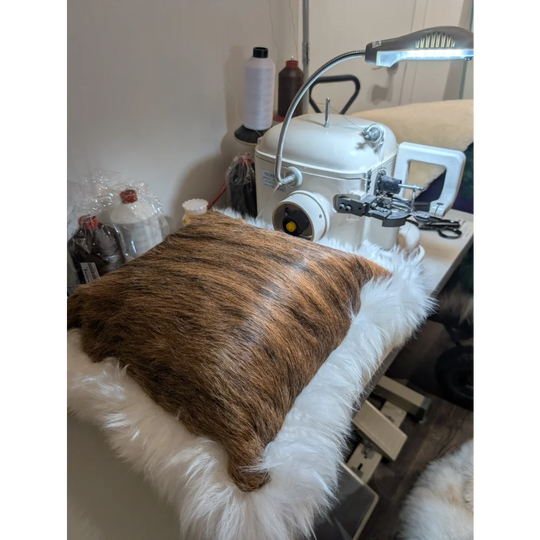 Brown and tan faux fur merino sheepskin pillow with plush white trim by angus oliver made in canada