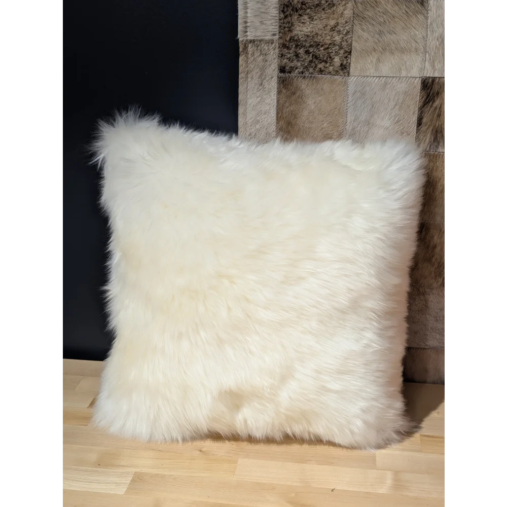 Cream-colored plush merino sheepskin throw pillow with soft fluffy texture by angus oliver canada