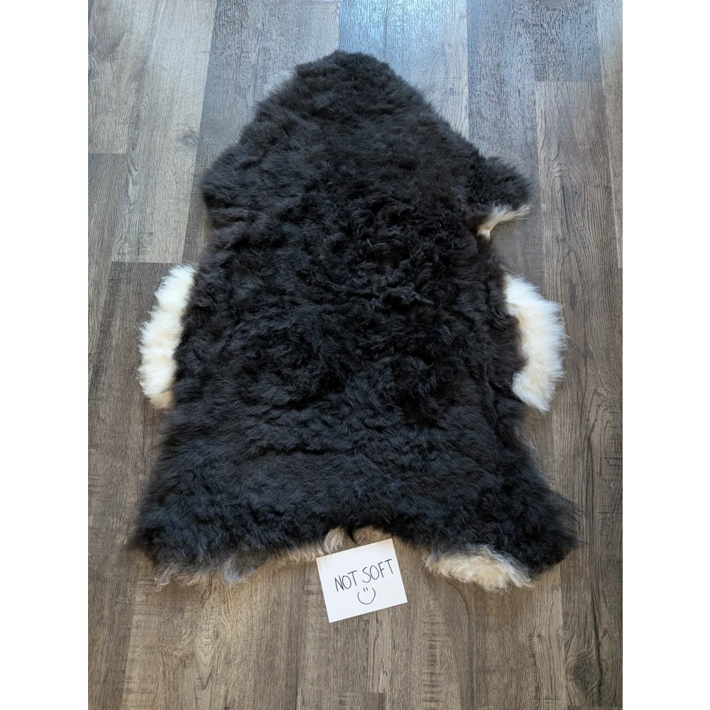 Black and white standard grade short wool white icelandic sheepskin rug with dense curly fur
