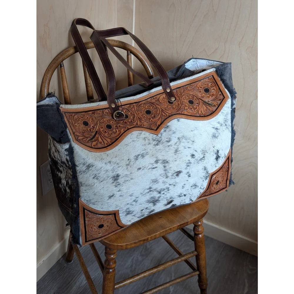 #1 the sunflower weekender bag is a rustic cartwright hand-tooled hair-on hide tote with zippered pocket panels