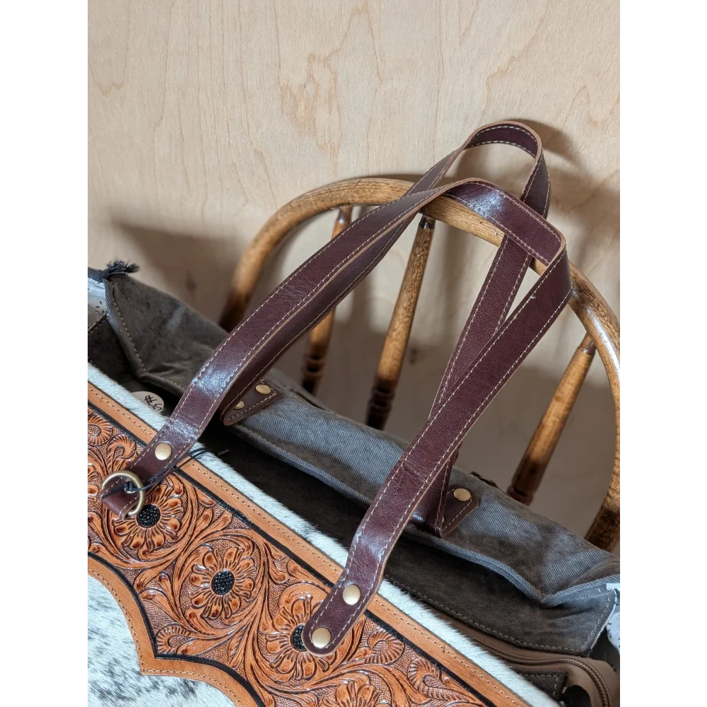 Brown leather sunflower weekender bag with intricate floral tooling hair-on hide trim and zippered pocket