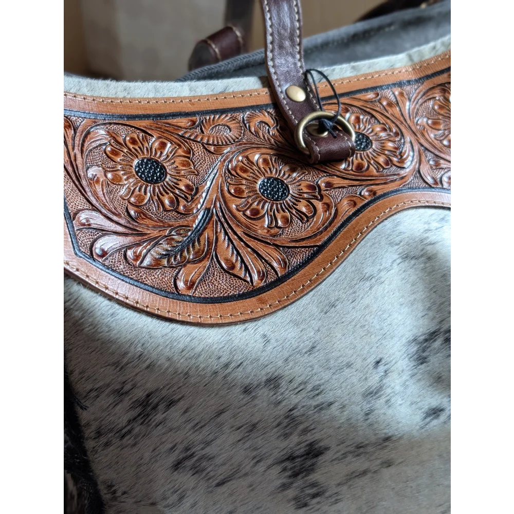 Brown leather strap with floral tooling and black stitching on hair-on hide #1 the sunflower weekender bag with zippered pocket