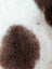 Brown fluffy highland spotted sheepskin patch on white background grade a- sheepskins detail