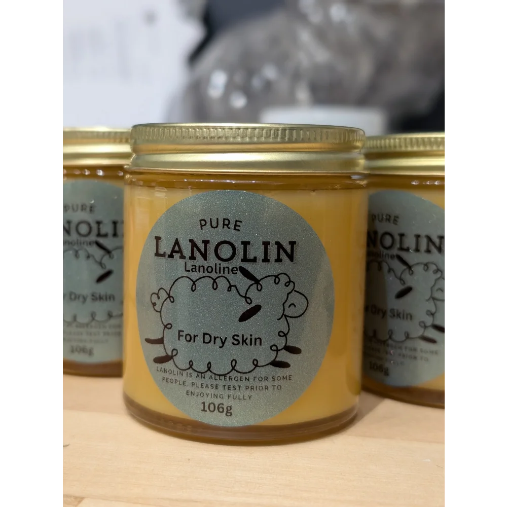 Yellow lanolin jar with silver lid for sheep’s wool humectant on cracked nipples