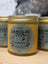 Yellow lanolin jar with silver lid for sheep’s wool humectant on cracked nipples