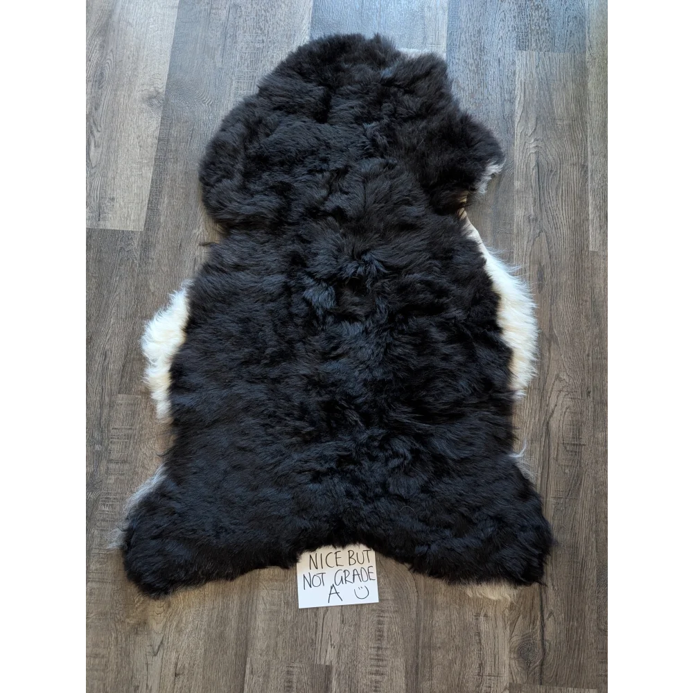 Black and white standard grade short wool white icelandic sheepskin rug with fluffy natural fur texture