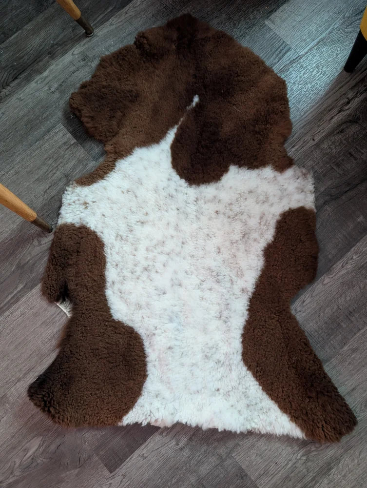Brown and white highland spotted sheepskin rug with fluffy natural texture grade a sheepskins for cozy decor