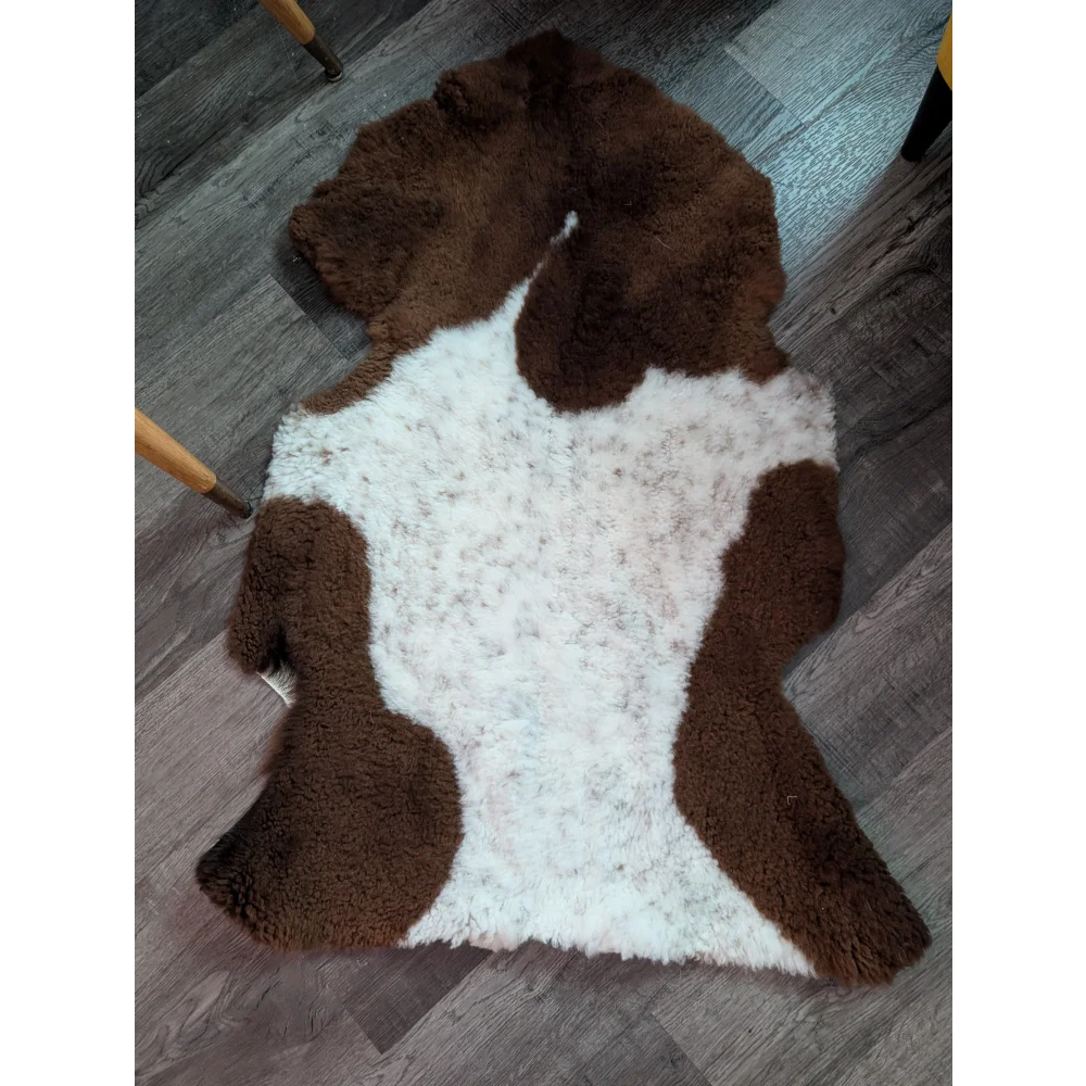 Brown and white highland spotted sheepskin rug with fluffy natural texture grade a sheepskins for cozy decor
