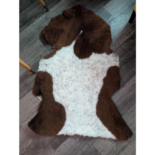 Brown and white highland spotted sheepskin rug with fluffy natural texture grade a sheepskins for cozy decor