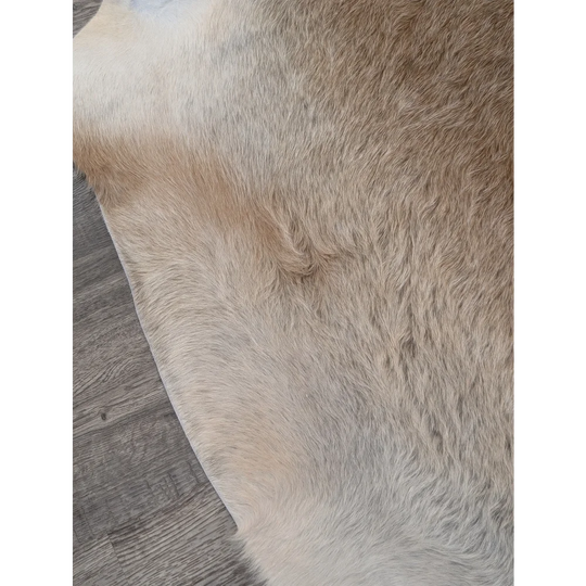 Beige and white extra large cowhide rug with natural fur texture perfect for adding rustic charm to your space