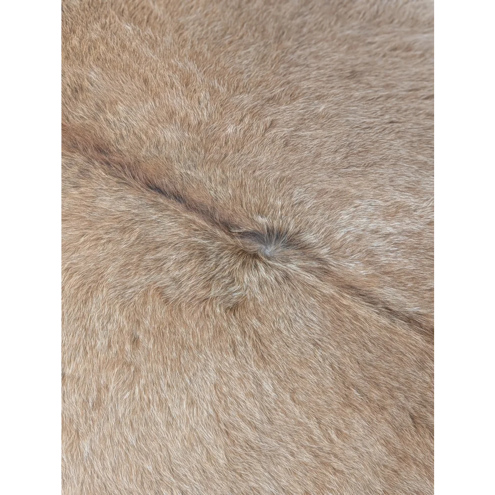 Tan faux fur extra large cowhide rug with soft dense texture and natural shade variations for rustic charm beautiful rugs