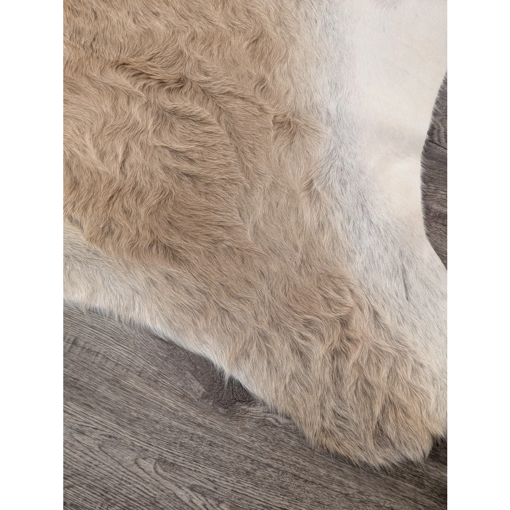 Beige and white extra large cowhide rug with soft shaggy faux fur texture perfect for adding rustic charm