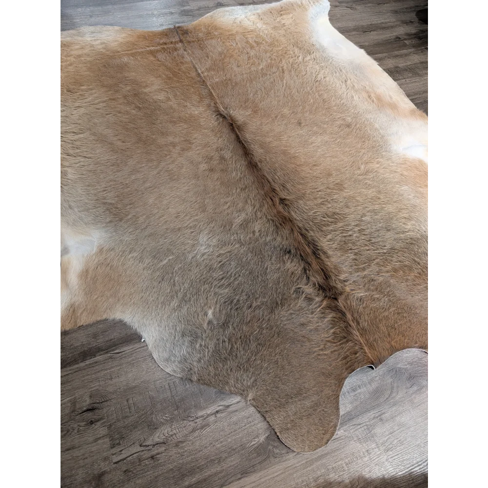 Tan and white extra large cowhide rug with natural fur texture perfect for adding rustic charm to beautiful rugs