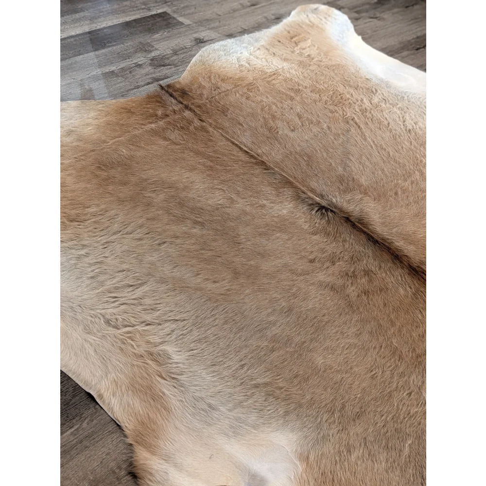 Tan and cream extra large cowhide rug with natural soft fur texture adds rustic charm to beautiful rugs collection