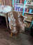 Brown and white highland spotted grade b sheepskin throw draped over chair perfect for cozy decor and sheepskin rugs