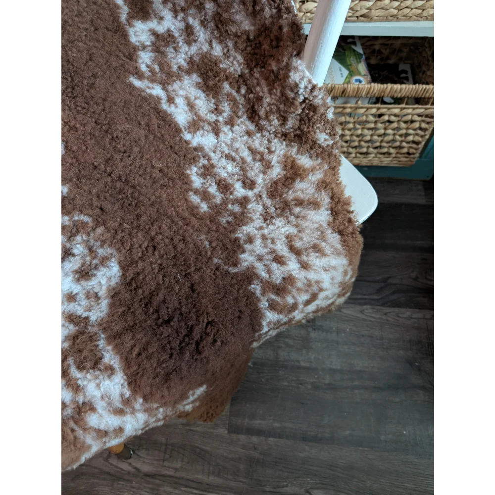 Brown and white fluffy highland spotted grade b sheepskin rug with natural textured surface perfect for cozy decor