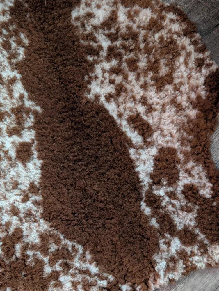 Brown and white cow-print faux fur grade b sheepskin rug highland spotted perfect for cozy home decor