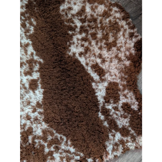 Brown and white cow-print faux fur grade b sheepskin rug highland spotted perfect for cozy home decor