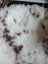 A plush white and brown spotted highland spotted grade a- sheepskin rug with soft curly texture