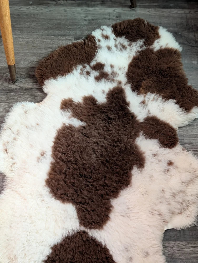 Brown and white cow-print highland spotted sheepskin rug grade a- sheepskins perfect for cozy decor