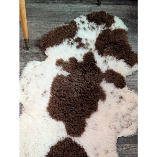 Brown and white cow-print highland spotted sheepskin rug grade a- sheepskins perfect for cozy decor