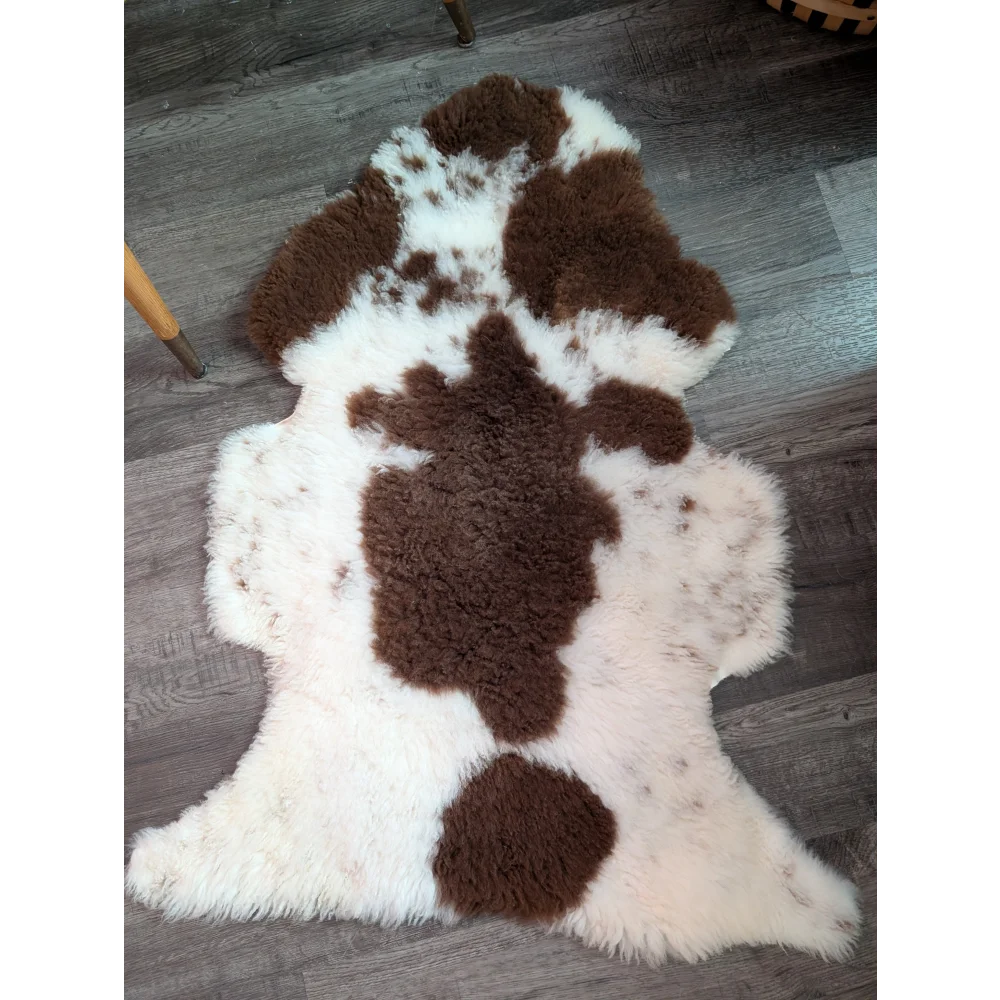 Brown and white highland spotted sheepskin rug with plush fluffy texture grade a sheepskins perfect for cozy decor