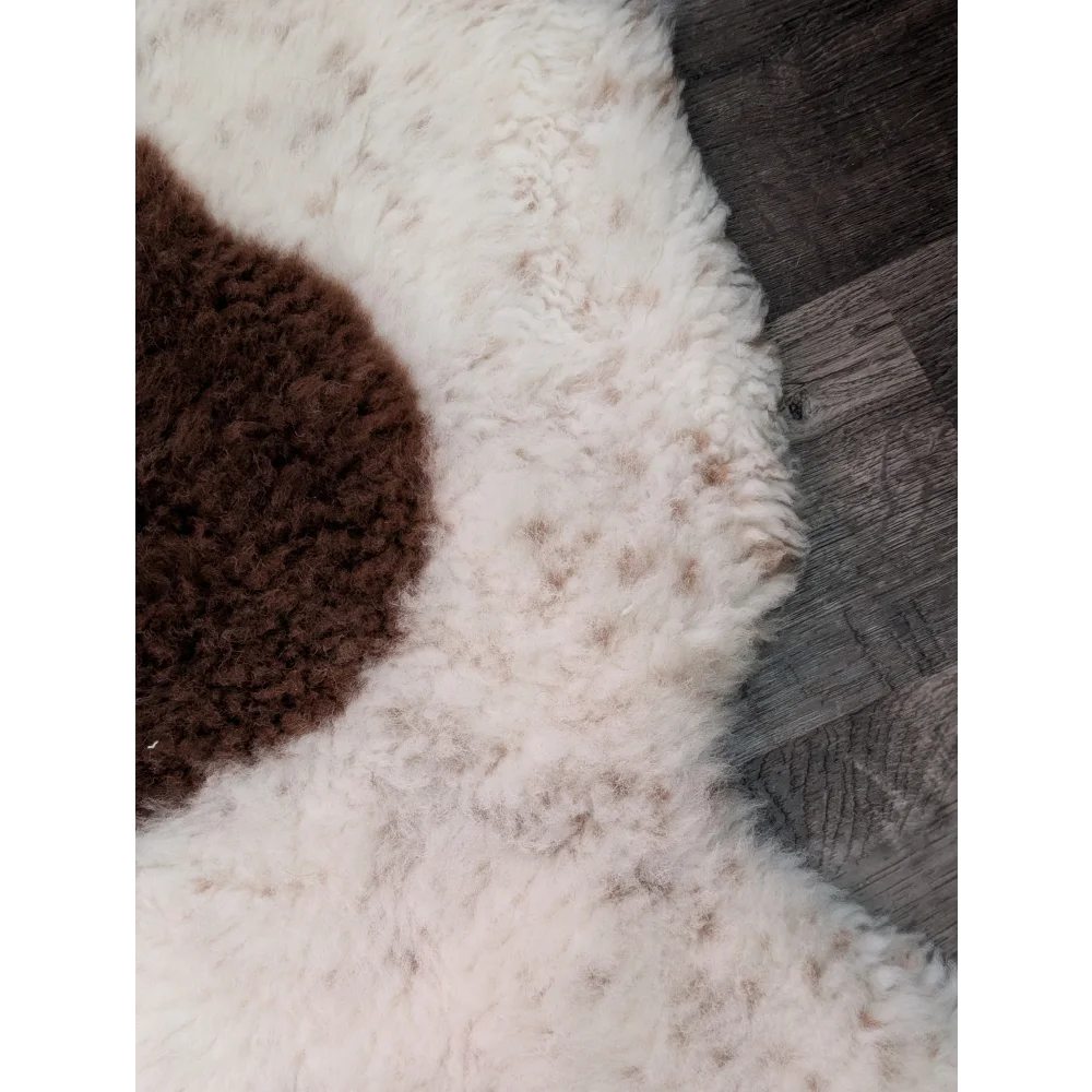 White and brown highland spotted sheepskin rug with fluffy textured surface grade a- sheepskins for cozy decor