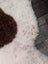 White and brown highland spotted sheepskin rug with fluffy textured surface grade a- sheepskins for cozy decor