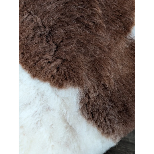 Brown and white highland spotted grade a- sheepskin rug with soft fluffy texture perfect for cozy decor