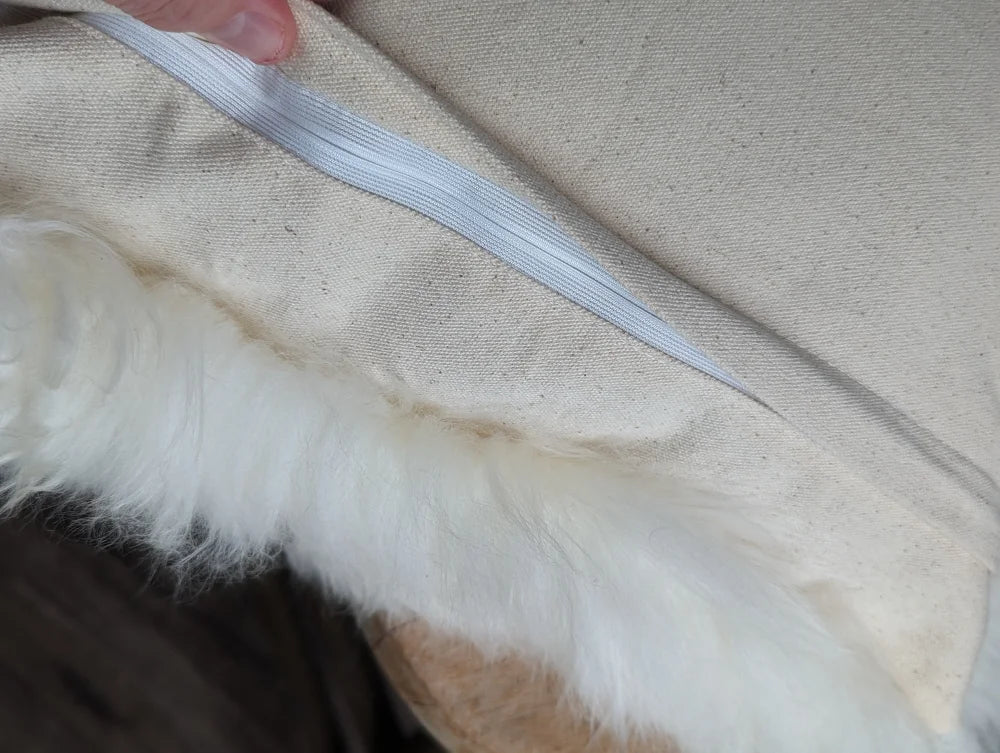 Natural white merino sheepskin cushion cover with fur-lined jacket texture
