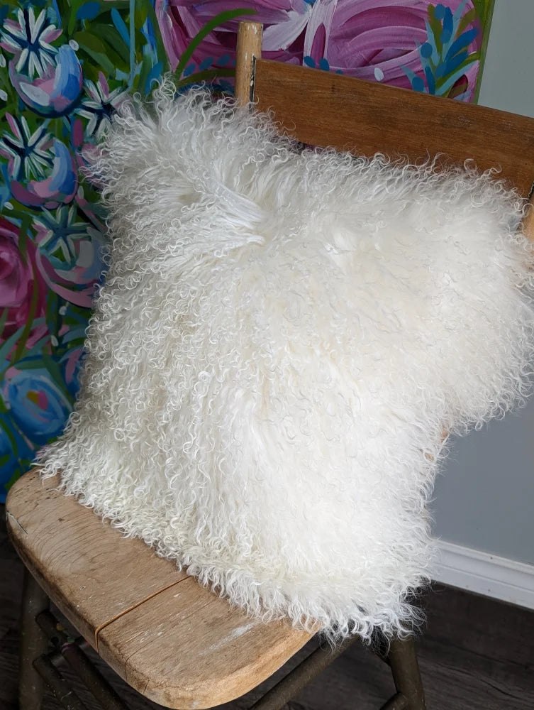 White fluffy Mongolian sheepskin cushion with textured faux fur surface
