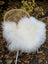 White fluffy large long wool natural white icelandic sheepskin draped over wicker chair cover