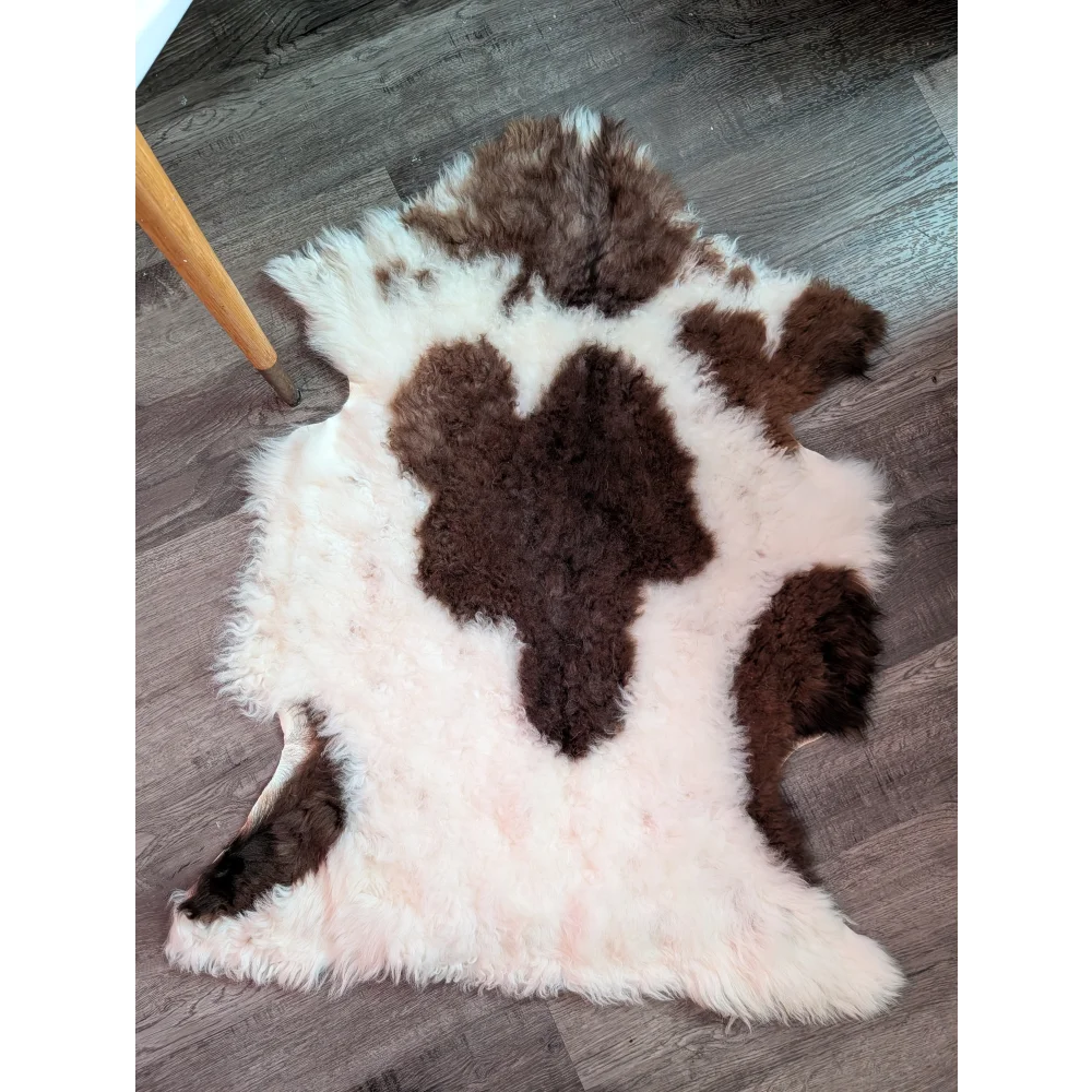 A fluffy tibet highland spotted natural cowhide rug with white and brown spots made from grade a- sheepskins
