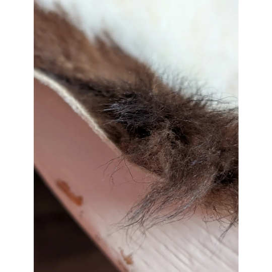 A fluffy brown and black fur trim from a tibet highland spotted grade a- sheepskin with soft textured appearance