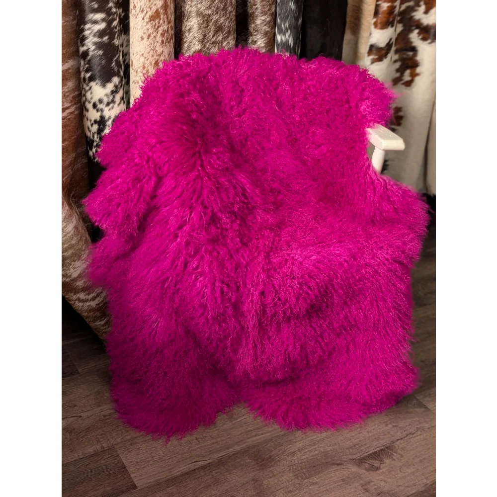Vibrant hot pink Angus Oliver sheepskin throw on white chair