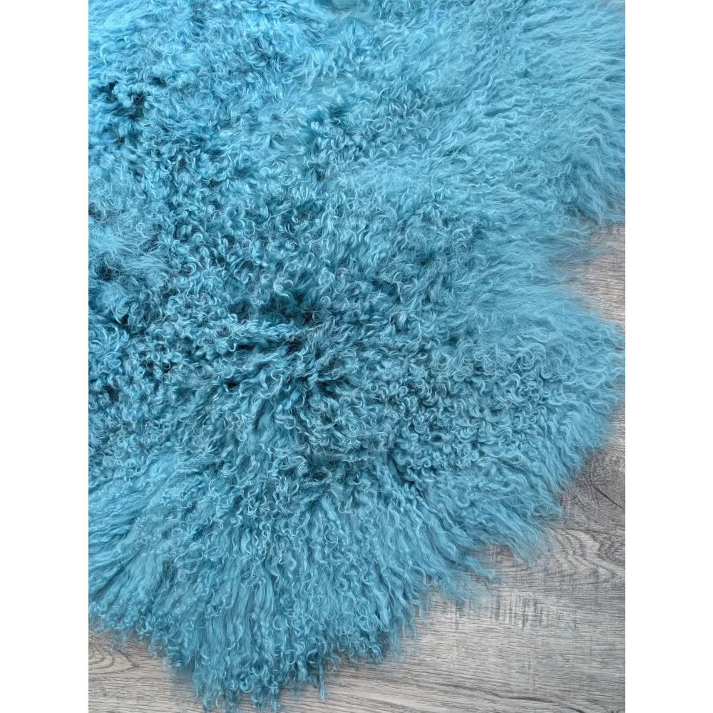 Plush aqua quad sized 72x48 Mongolian sheepskin rug with fluffy texture