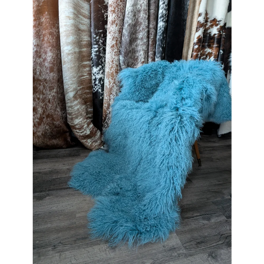 Vibrant turquoise 72x48 aqua quad Mongolian sheepskin rug on chair