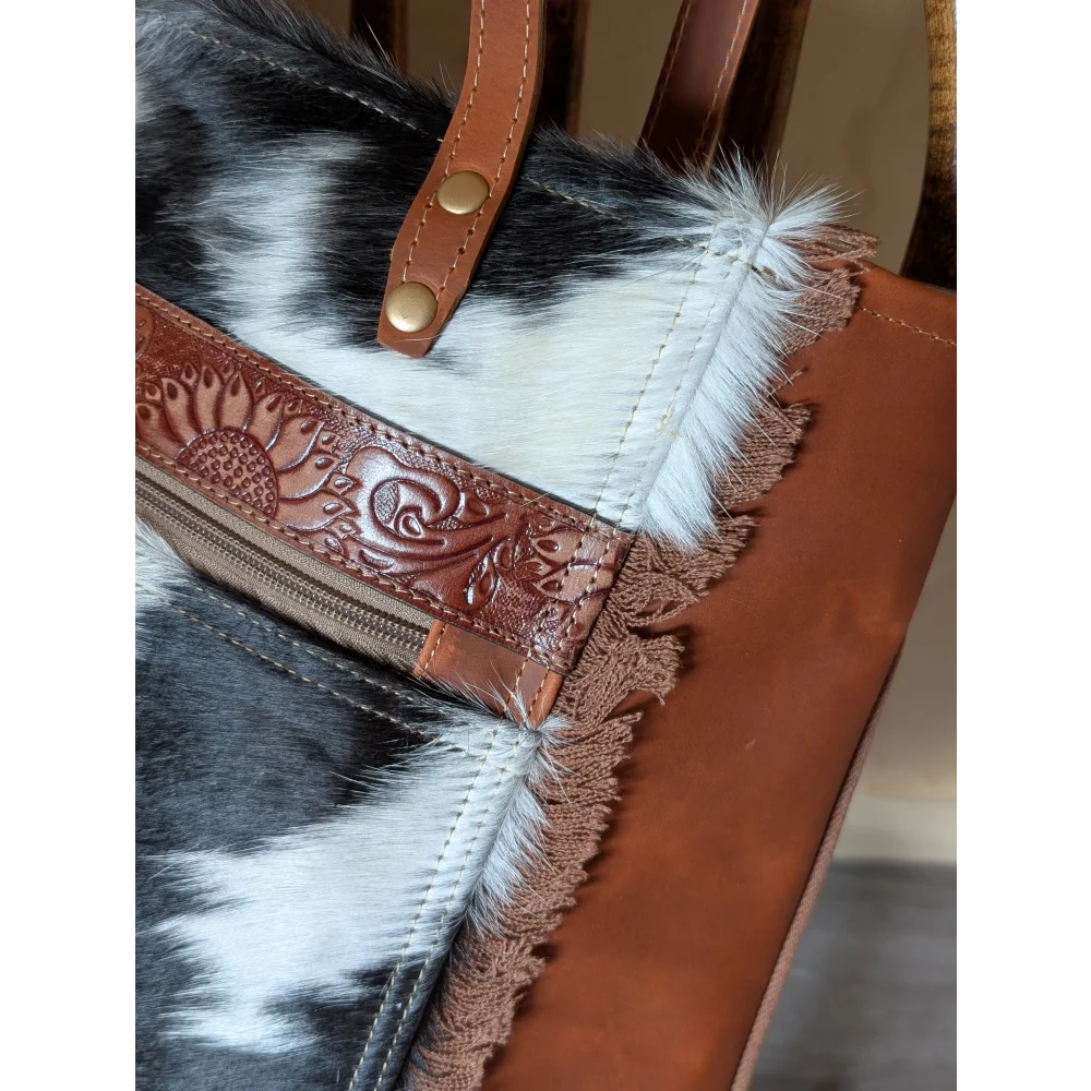 Brown leather strap with floral embossing and gold hardware accented by frayed real cowhide on #2 oakley bag